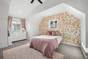 Carpeted bedroom featuring lofted ceiling, wallpapered walls, recessed lighting, and a ceiling fan