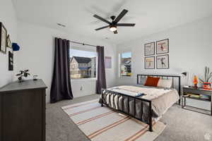 Bedroom with light carpet and a ceiling fan
