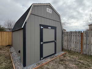 View of shed featuring a fenced backyard