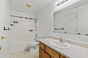 Full bathroom featuring vanity, shower / bath combination, a textured ceiling, and light floors