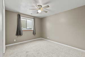 Unfurnished room with carpet, ceiling fan, and a textured ceiling