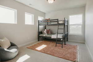 Carpeted bedroom featuring baseboards