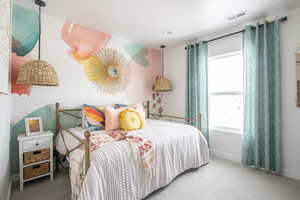 Bedroom featuring carpet floors and baseboards