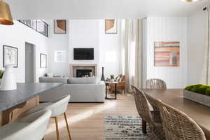 Living area featuring light wood finished floors and a glass covered fireplace