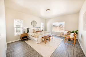 Bedroom with wood finished floors and baseboards