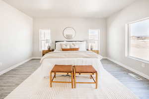 Bedroom featuring light wood-style floors and baseboards