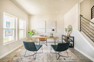 Office space featuring wood finished floors and recessed lighting