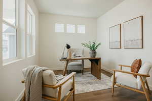 Home office with wood finished floors and baseboards