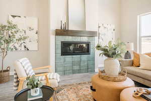 Living area featuring a tile fireplace and wood finished floors