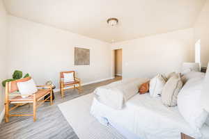 Bedroom with baseboards and wood finished floors