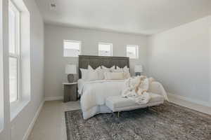 Bedroom featuring carpet flooring and multiple windows