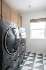 Laundry room featuring cabinet space and washing machine and clothes dryer