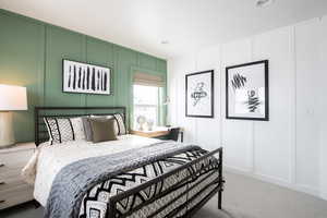 Carpeted bedroom featuring a decorative wall and recessed lighting