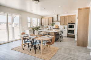 Dining area with recessed lighting and light wood finished floors