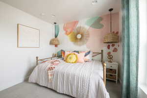 Carpeted bedroom featuring baseboards