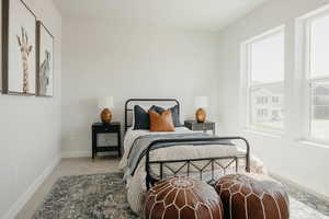 Carpeted bedroom featuring baseboards