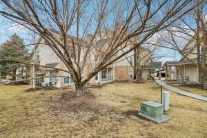 View of side of home with a yard