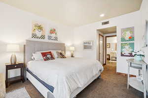 Carpeted bedroom with baseboards