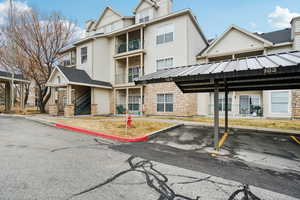 View of building exterior with covered parking