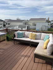 Wooden terrace featuring outdoor lounge area and a residential view