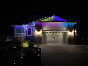 View of front of home with brick siding, a garage, and concrete driveway