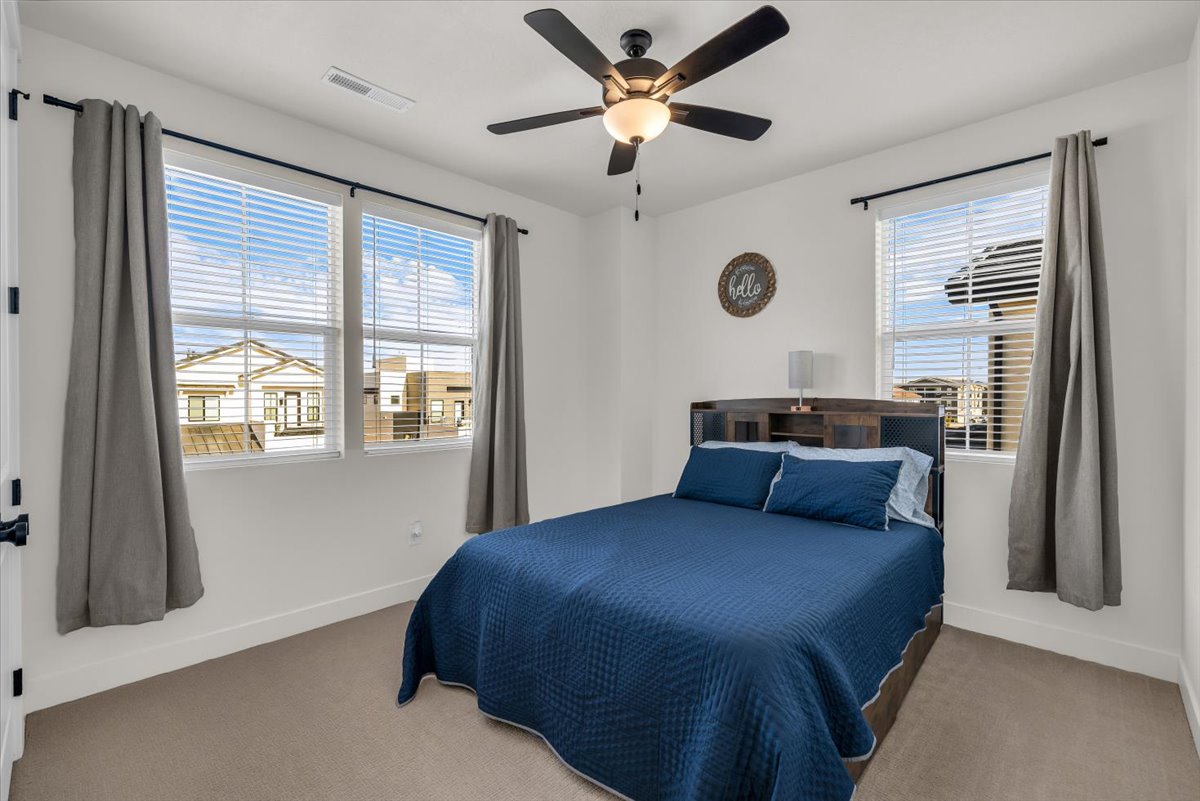 Bedroom with carpet flooring and a ceiling fan