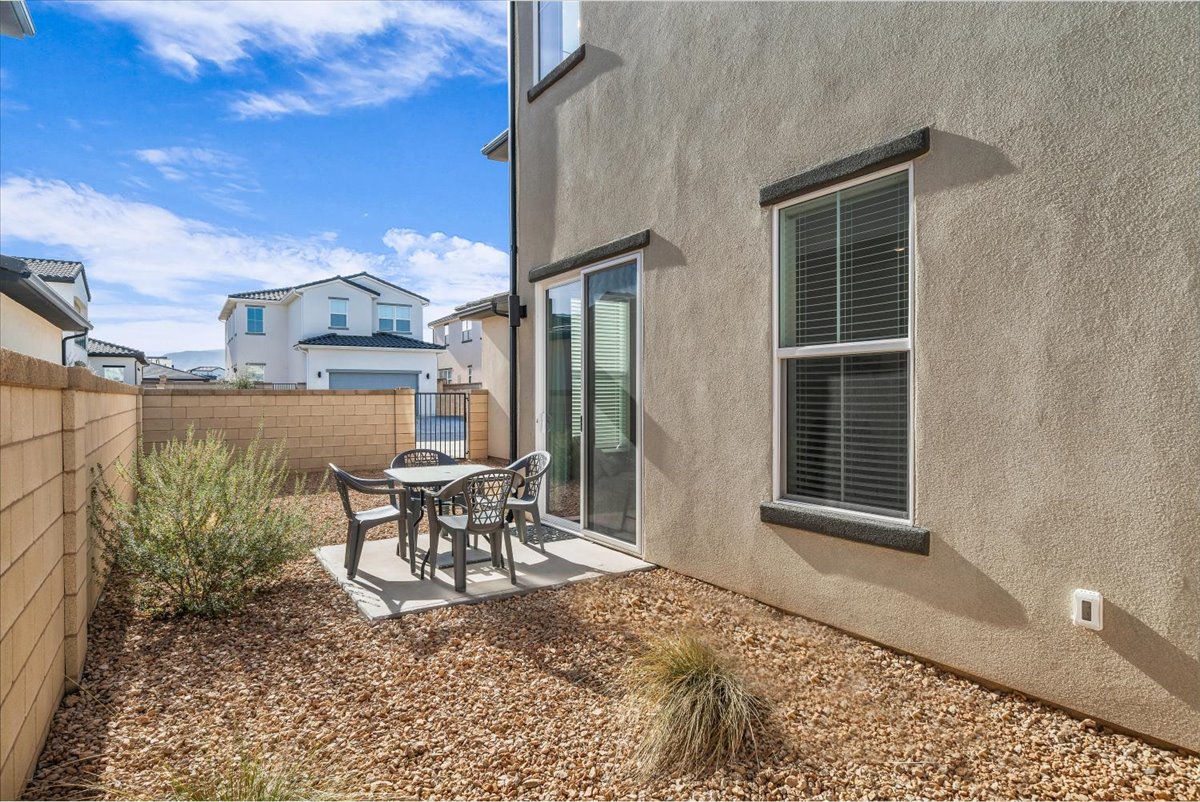Fenced backyard with a patio area and outdoor dining space