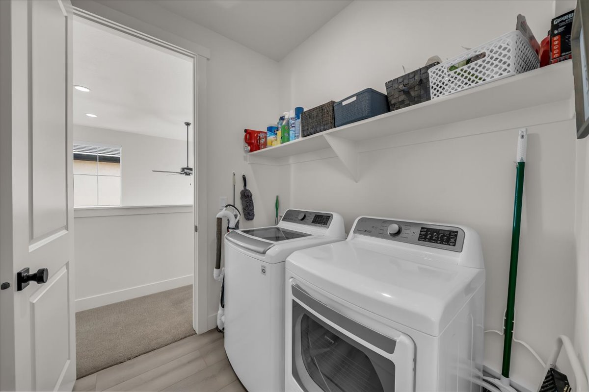Laundry room with washer and dryer, recessed lighting, and light wood-type flooring