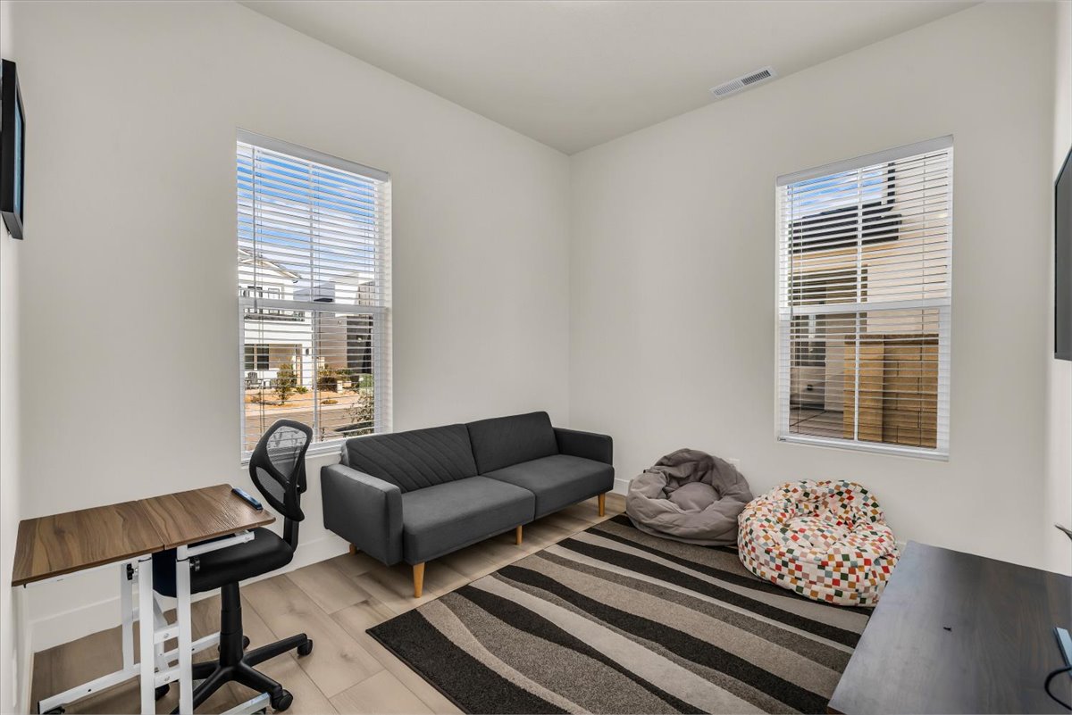 Office space with light wood-type flooring and healthy amount of natural light