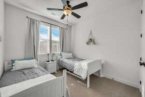Bedroom with carpet flooring and ceiling fan