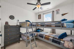 Bedroom featuring light colored carpet and a ceiling fan