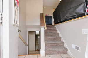 Stairway featuring tile patterned floors