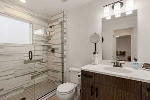 Bathroom with vanity, a stall shower, and connected bathroom