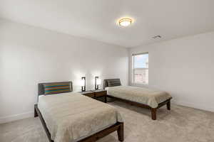 Bedroom with light colored carpet