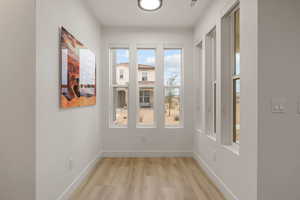 Unfurnished dining area featuring baseboards and wood finished floors
