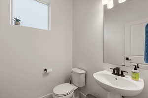 Half bathroom with toilet and a sink