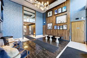 Community lobby with a tray ceiling and recessed lighting