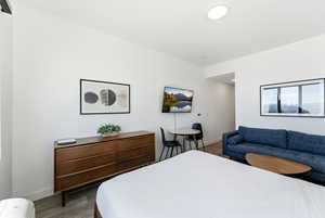 Bedroom featuring baseboards and wood finished floors