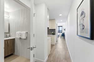 Corridor featuring light wood-style flooring and recessed lighting