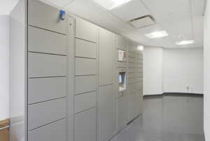 View of home's community featuring a package area and a drop ceiling