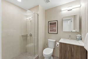 Bathroom featuring vanity and a stall shower