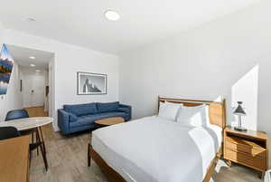 Bedroom with wood finished floors and recessed lighting