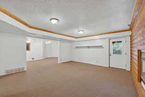 Below grade area with a textured ceiling and carpet