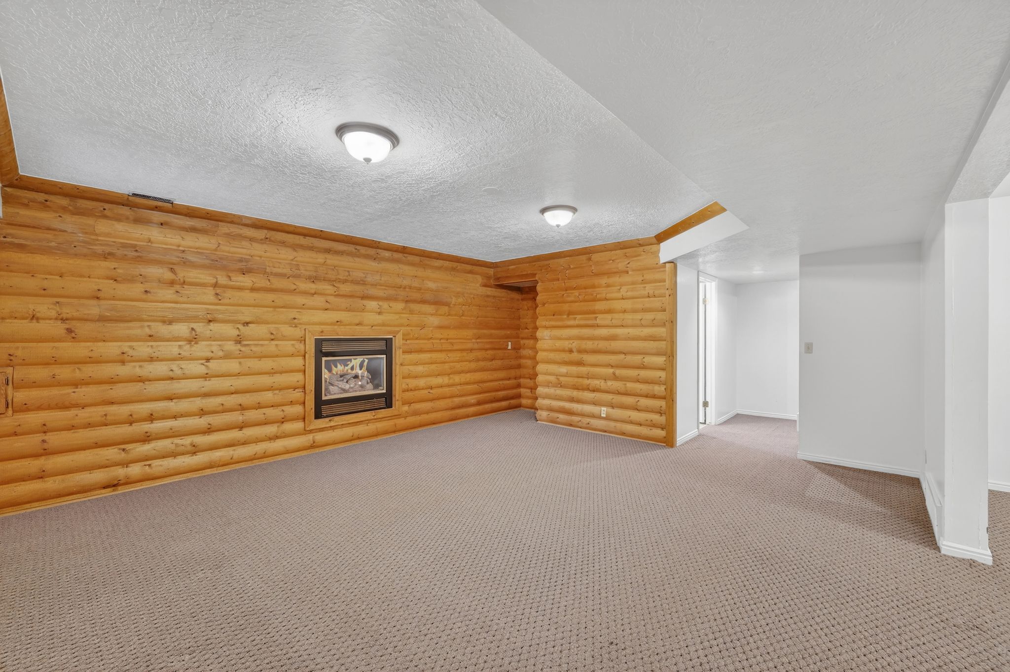 Finished below grade area featuring carpet and a textured ceiling