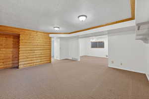 Finished below grade area with carpet, a textured ceiling, and ceiling fan