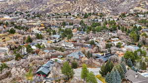 Aerial overview of property's location with nearby suburban area and mountains