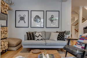 Living area with stairway and wood finished floors