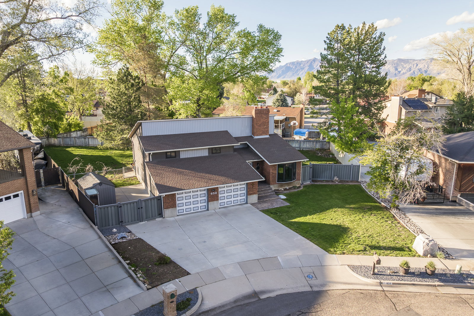 Aerial perspective of suburban area with a mountainous background