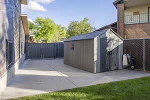 View of shed featuring a gate and a fenced backyard