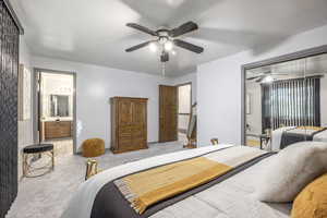 Bedroom featuring carpet, ceiling fan, a closet, and connected bathroom